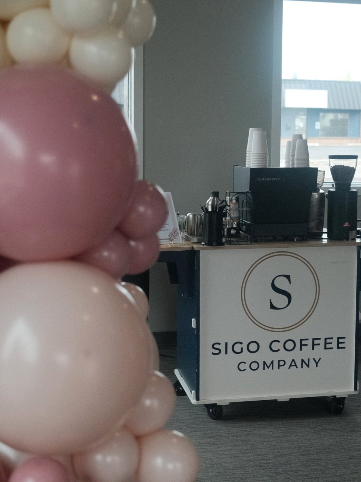 The Sigo Coffee Company cart set up behind a pink and cream balloon garland at a private celebration in Spokane
